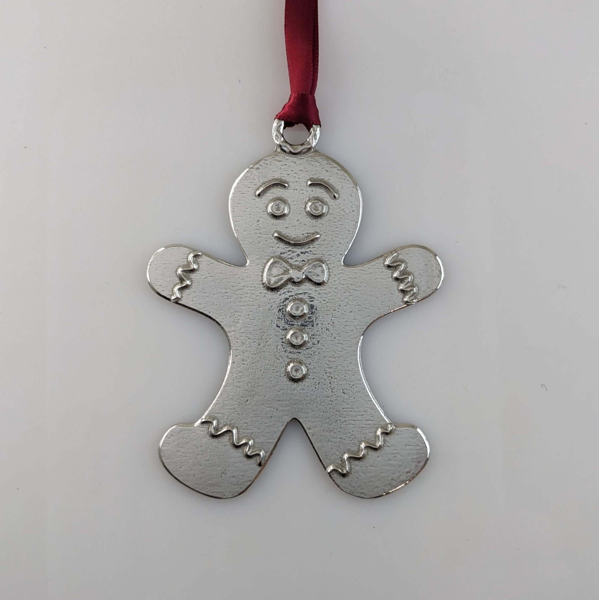 pewter gingerbread man on grey background