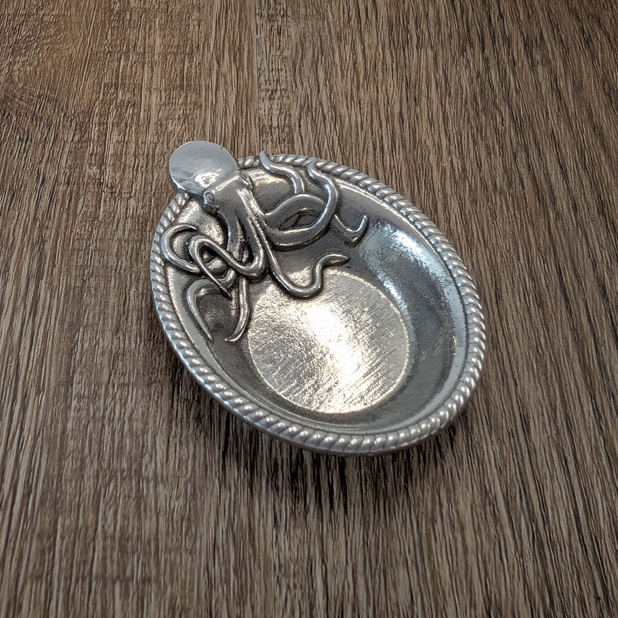 Pewter Octopus ring dish on wood surface