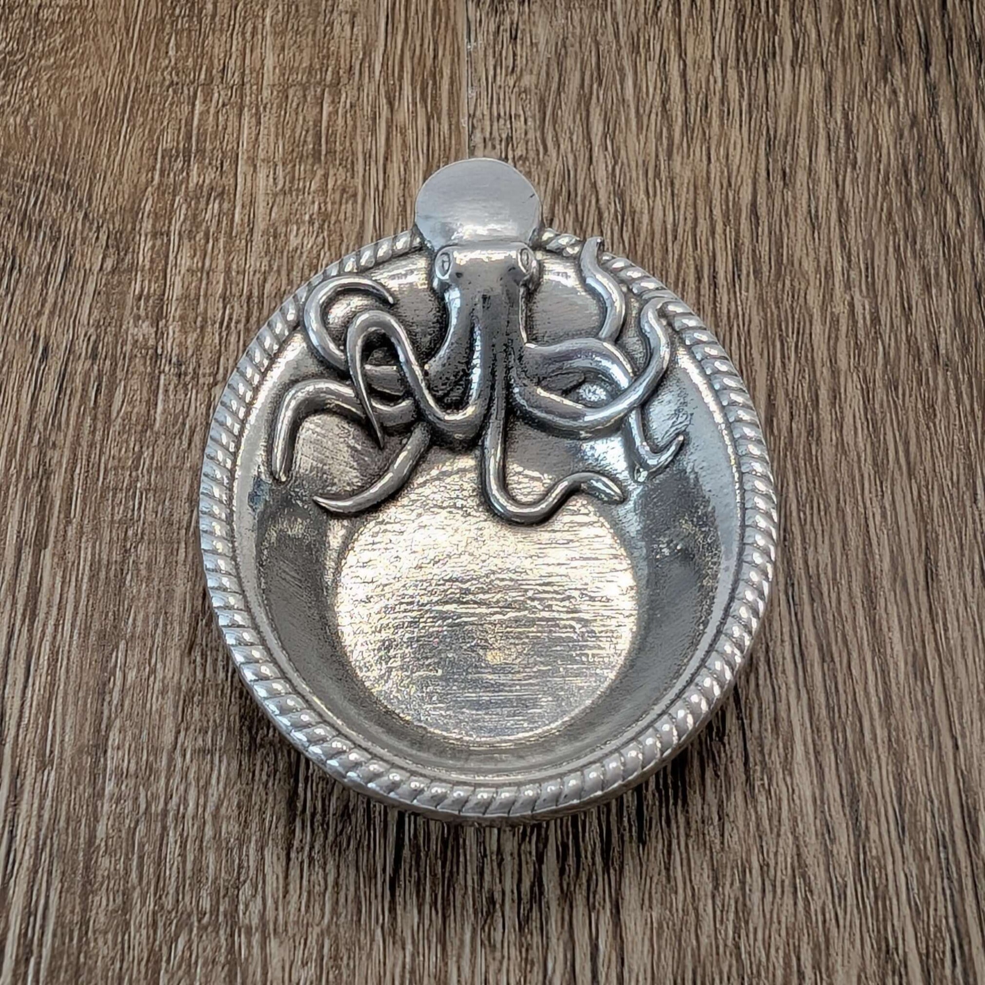 Pewter Octopus ring dish on wood surface
