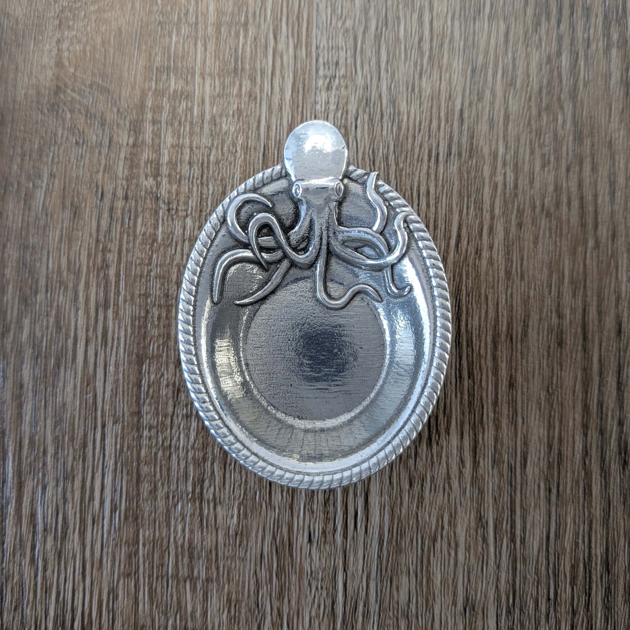 Pewter Octopus ring dish on wood surface