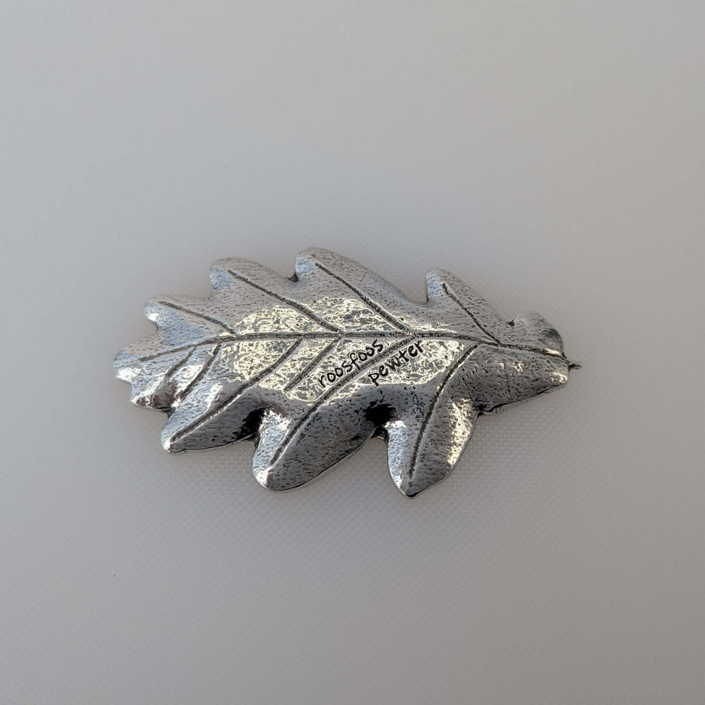 Pewter oak leaf ring dish on white surface