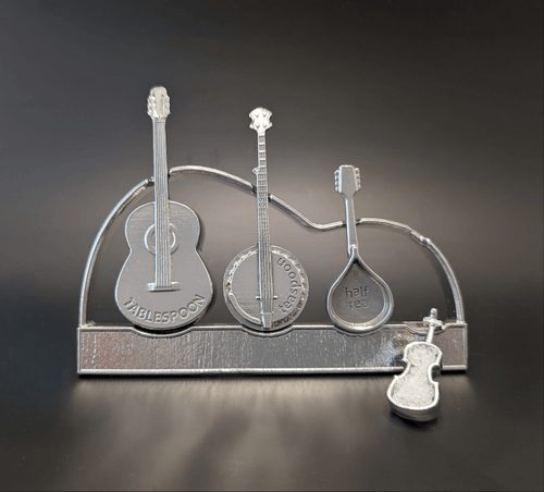 Pewter instrument guitar spoons on display stand. Guitar, banjo, mandolin, fiddle. Black background