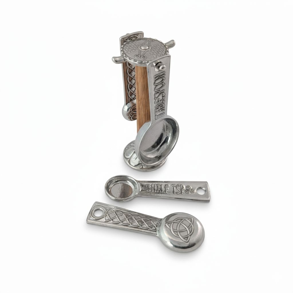 Set of decorative metal spoons with Celtic designs on a white background