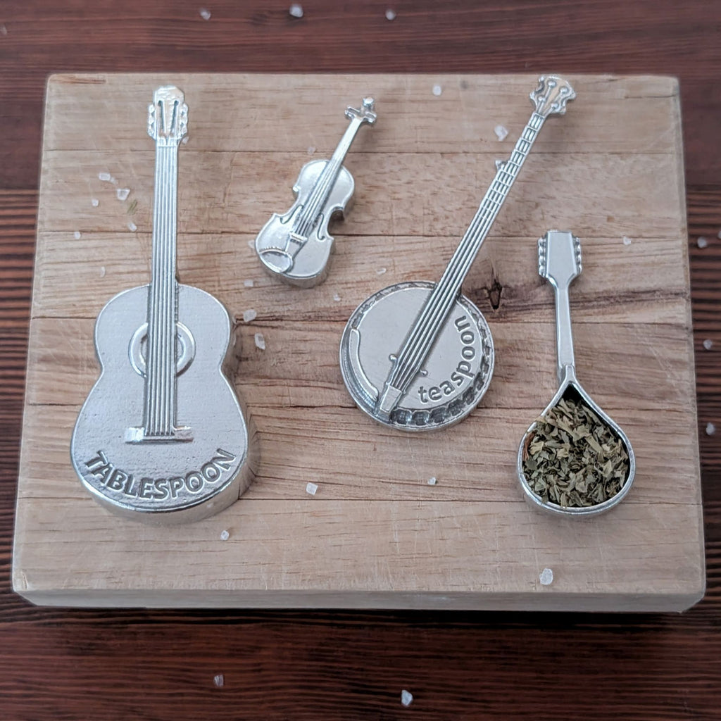 Set of musical instrument-shaped spoons on a wooden board