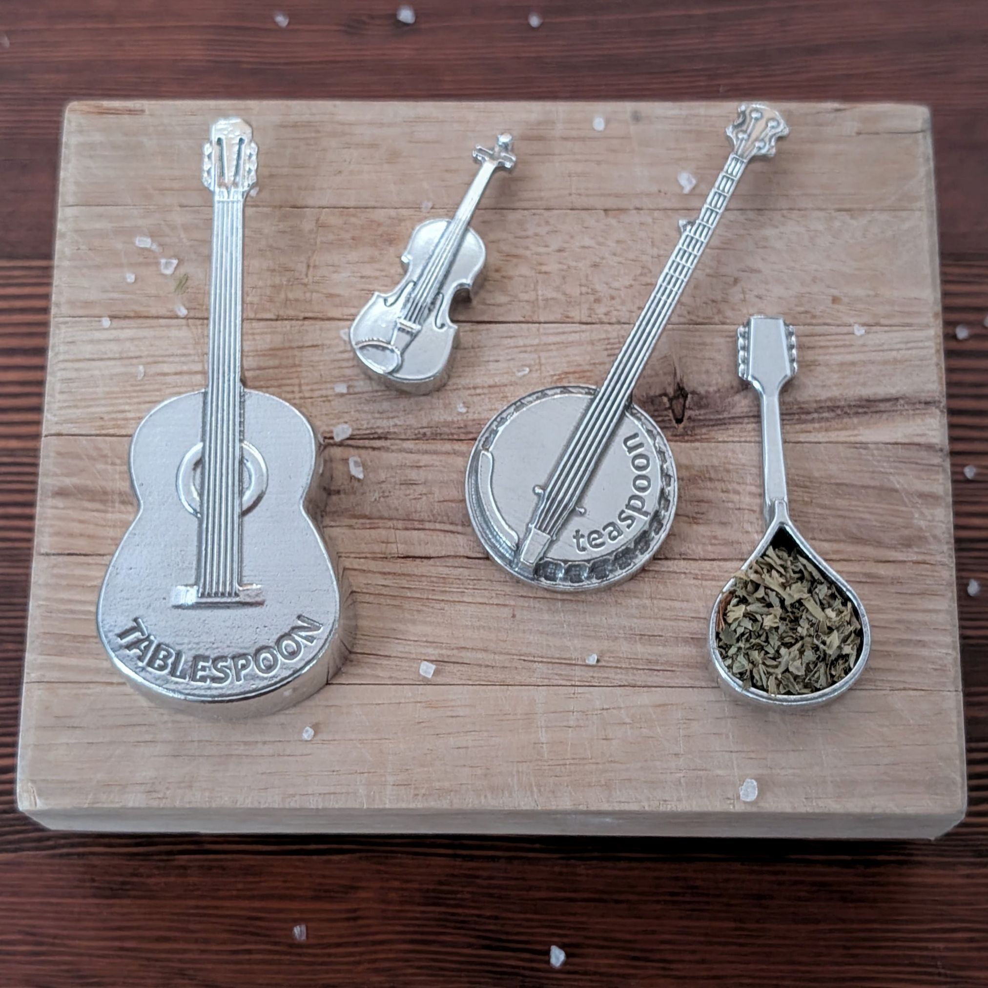 Set of musical instrument-shaped spoons on a wooden board