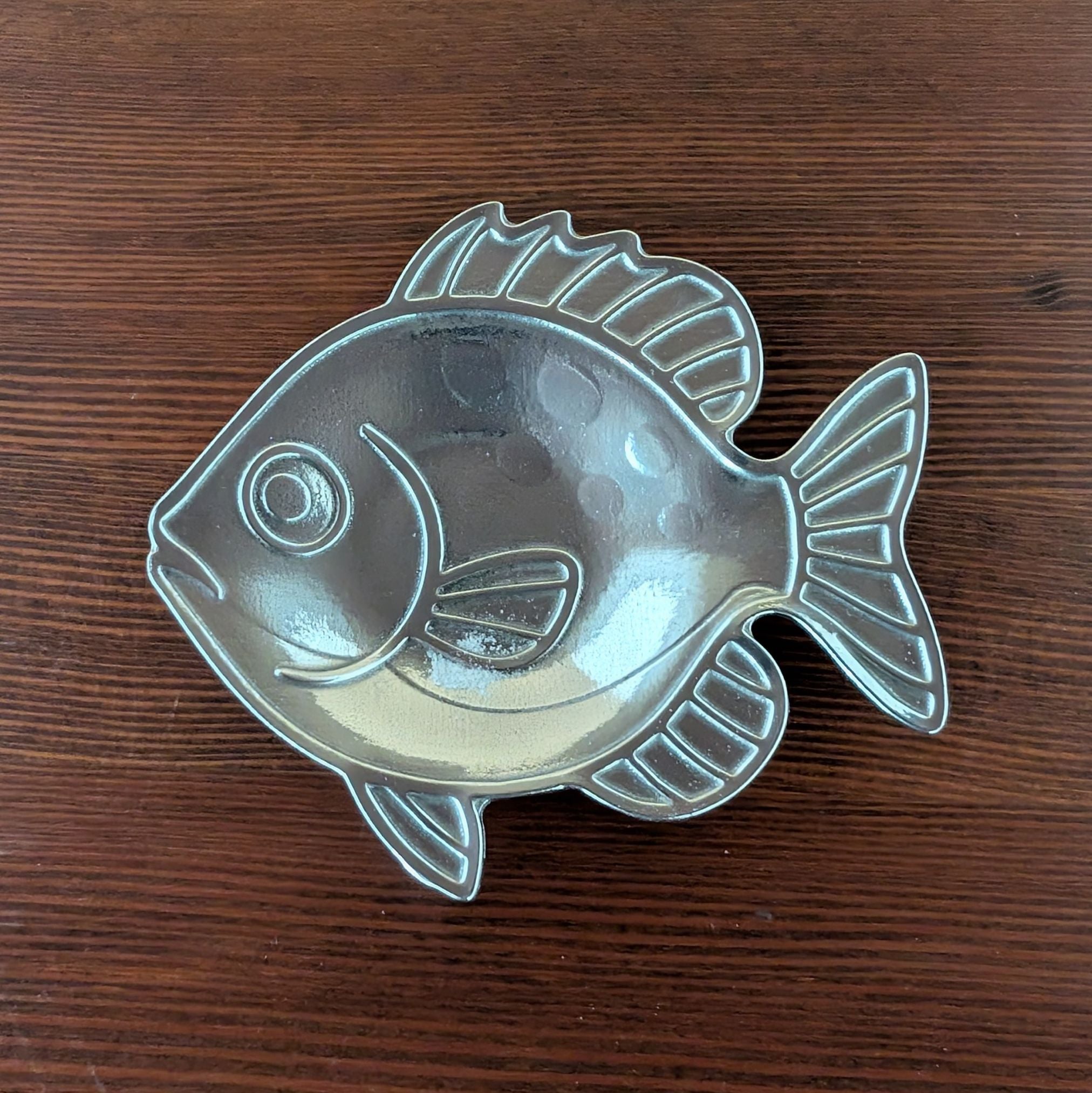Pewter fish dish on wood