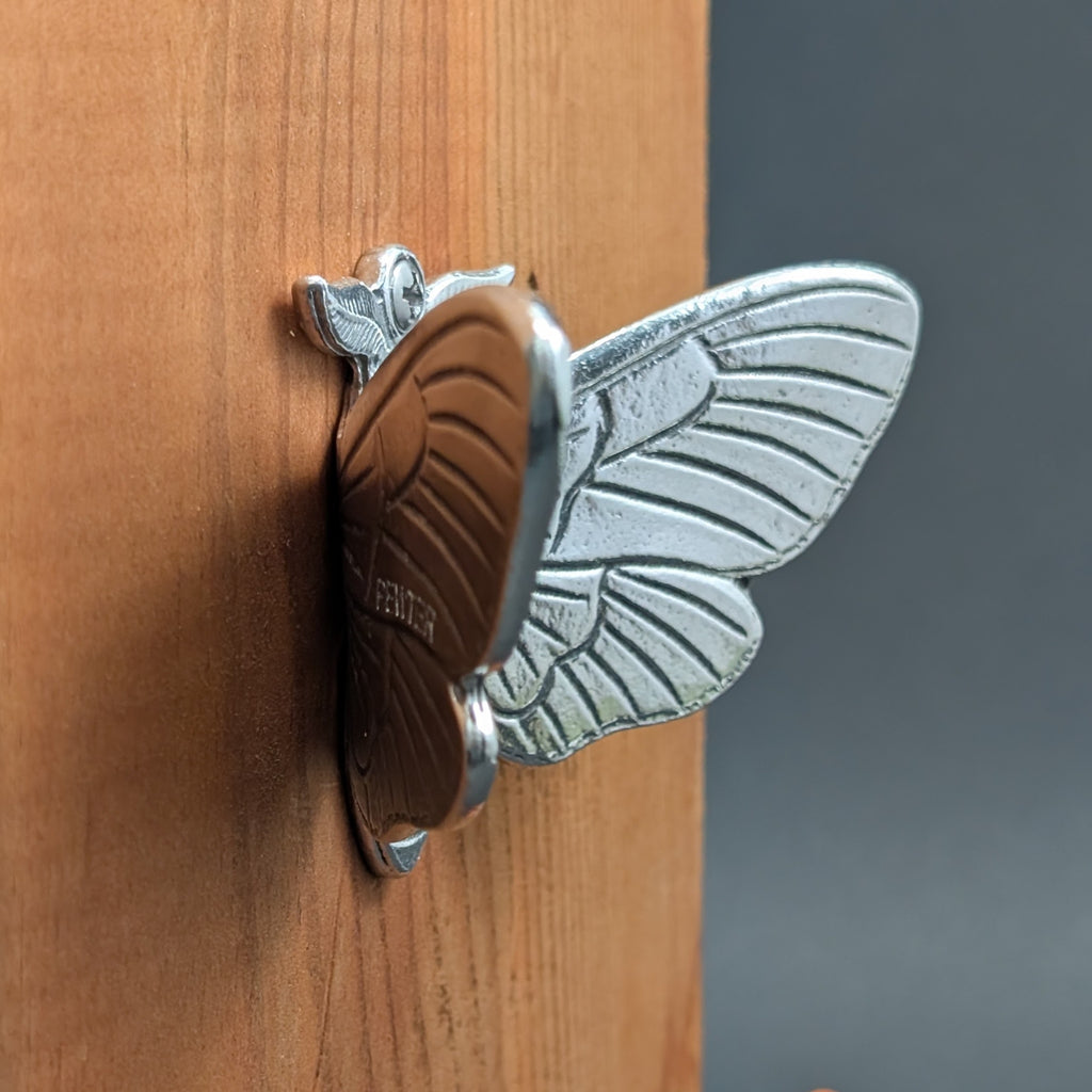 Close-up of a pewter death's head hawkmoth wall hook showing wing detail