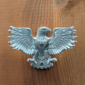 Pewter eagle wall hook mounted on a wood board, front view