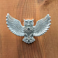 Pewter owl wall hook mounted on a wood board, front view
