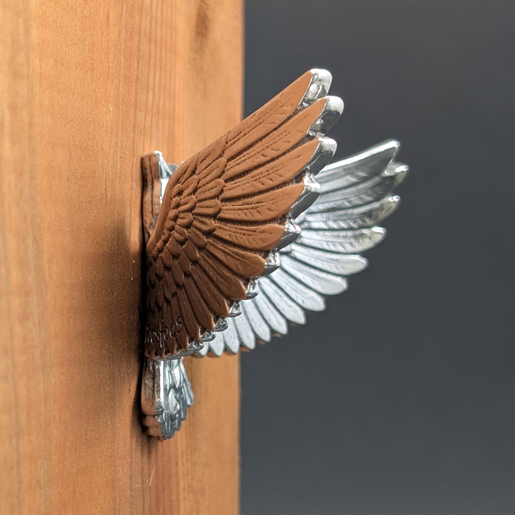 Close-up of a pewter owl wall hook showing feather and face detail