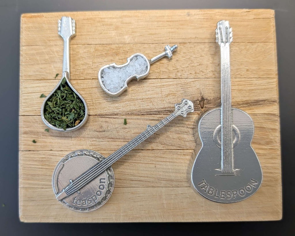 Pewter instrument guitar spoons- Guitar, banjo, mandolin, fiddle. On wood