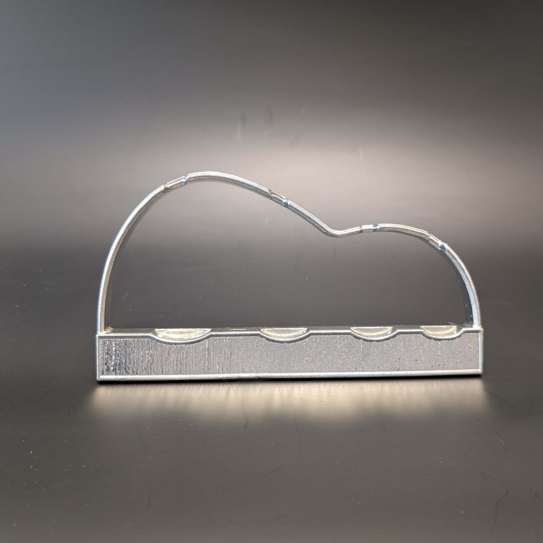 Pewter display stand on black background