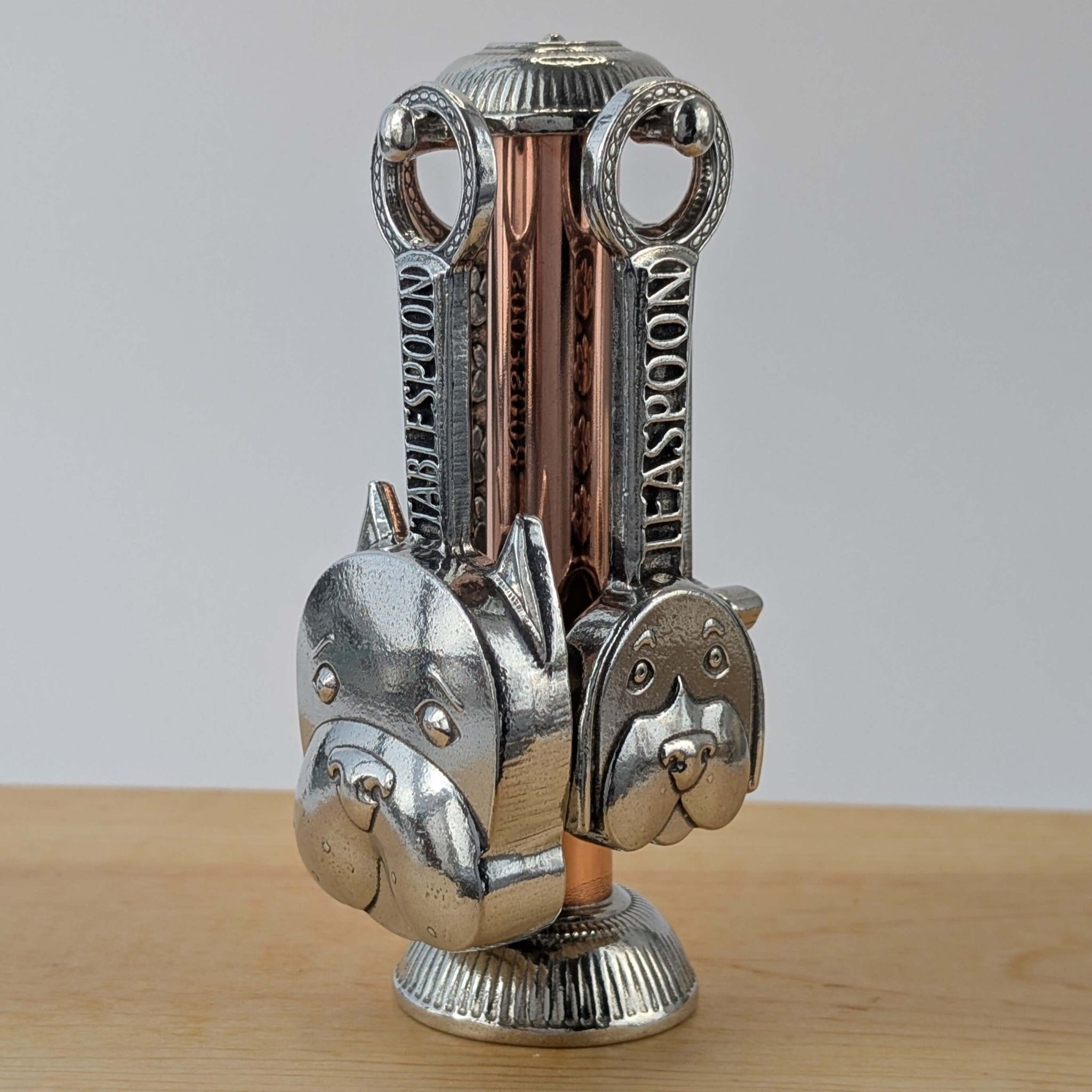 Pewter dog measuring spoons with  copper stand