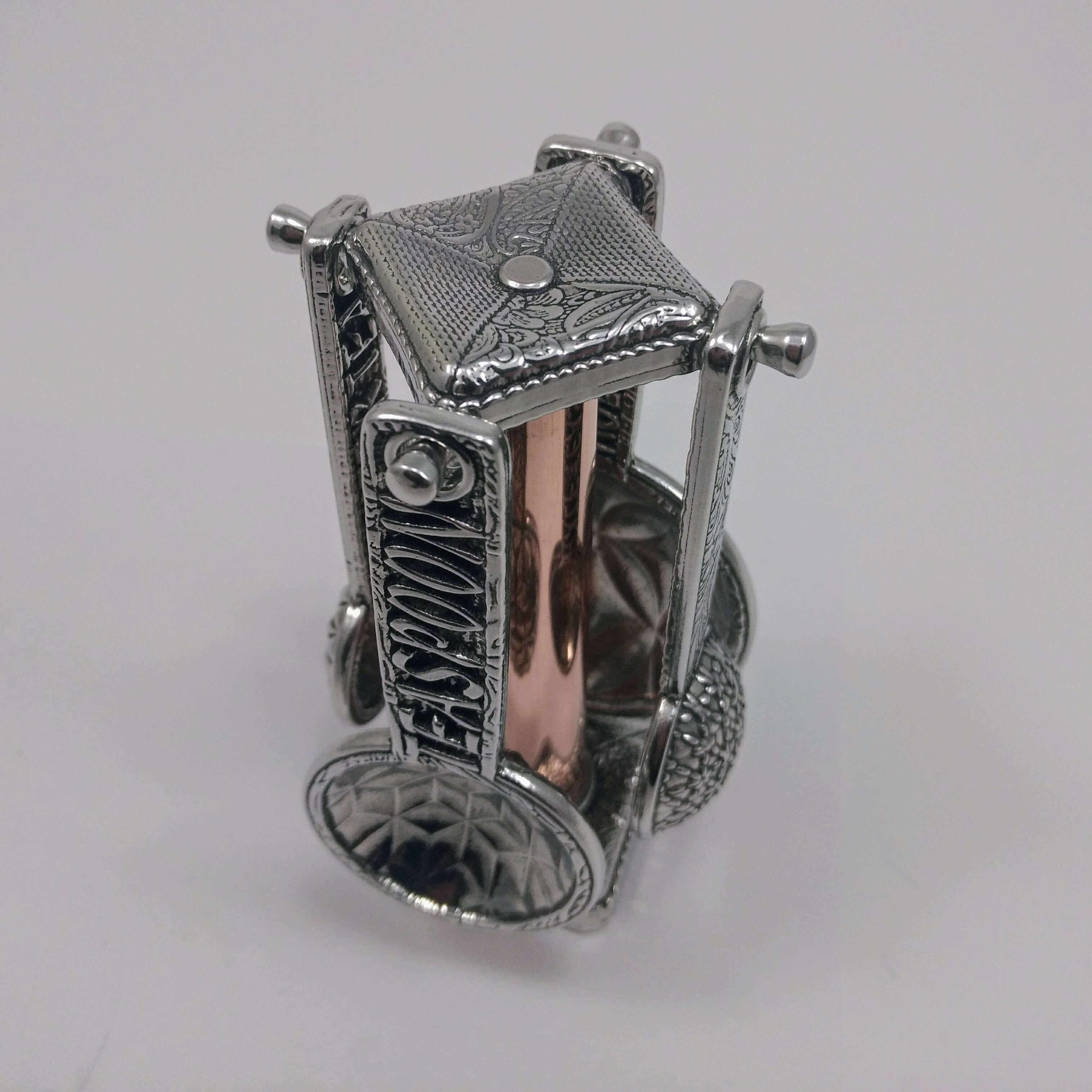 Pewter measuring spoons on copper stand-